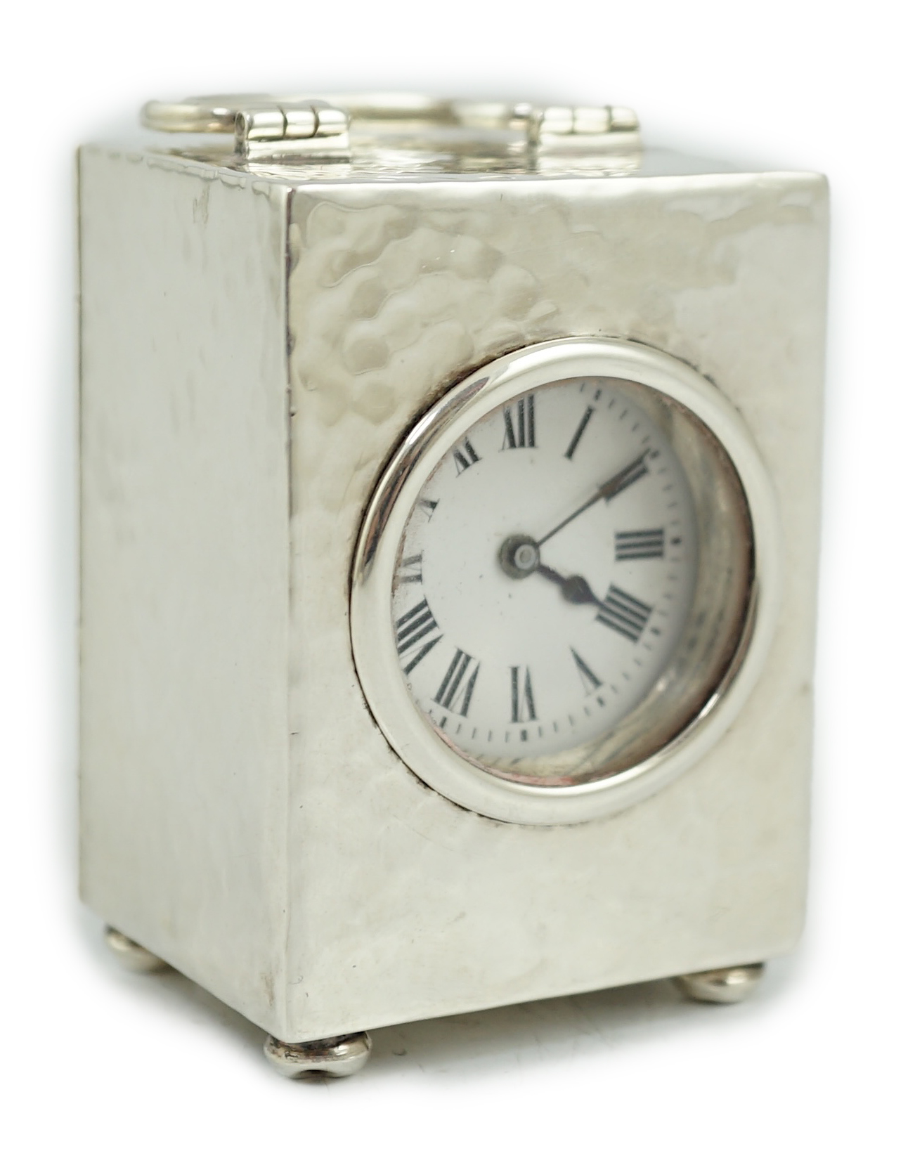 An Edwardian planished silver miniature carriage timepiece, by Arthur Baume & Co